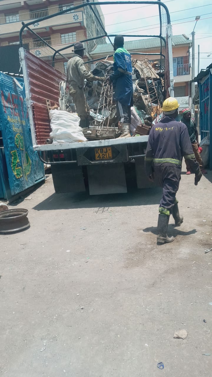 Scrap metal dealers weighing materials in Nairobi, Kenya